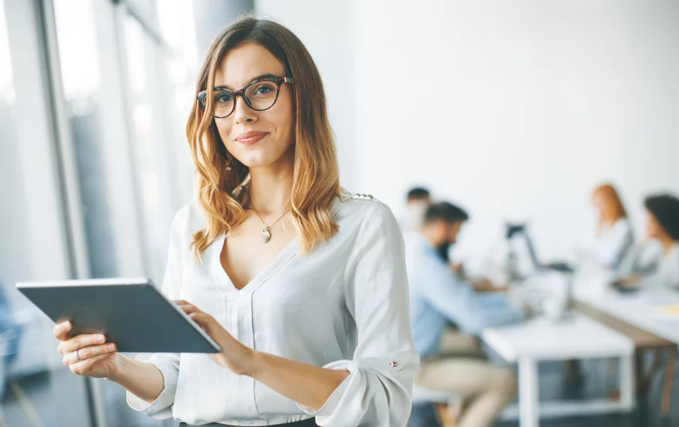 An insurance company employee poses with a notebook in her hand